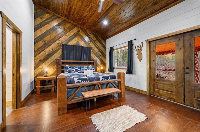 bedroom featuring wooden ceiling, baseboards, wood-type flooring, and wood walls