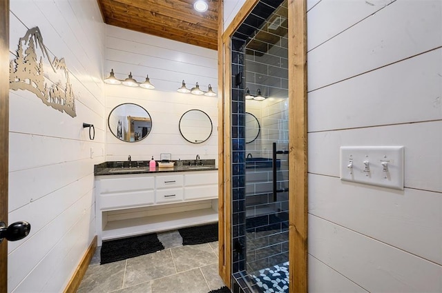bathroom featuring double vanity, wood ceiling, a sink, wooden walls, and tiled shower