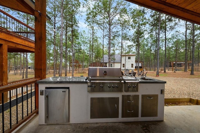 view of patio with area for grilling and a sink