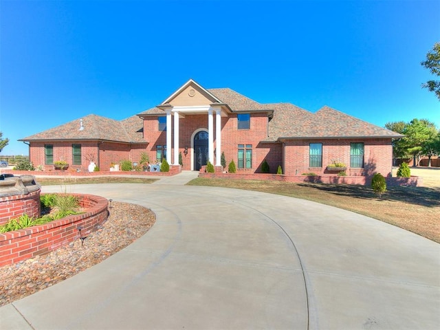 6363 NW 220th St, Edmond, OK 73025 - view of front of house with brick siding and curved driveway