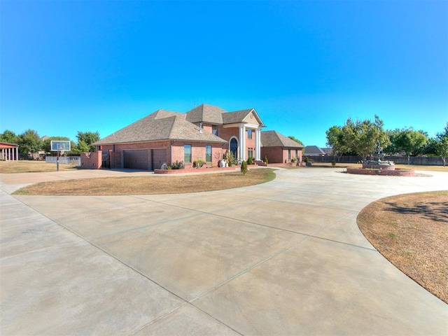 6363 NW 220th St, Edmond, OK 73025 - view of front of home with a garage, brick siding, and curved driveway
