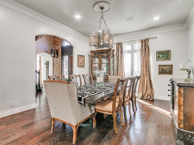 6363 NW 220th St, Edmond, OK 73025 - dining room featuring arched walkways, dark wood-type flooring, crown molding, baseboards, and a chandelier