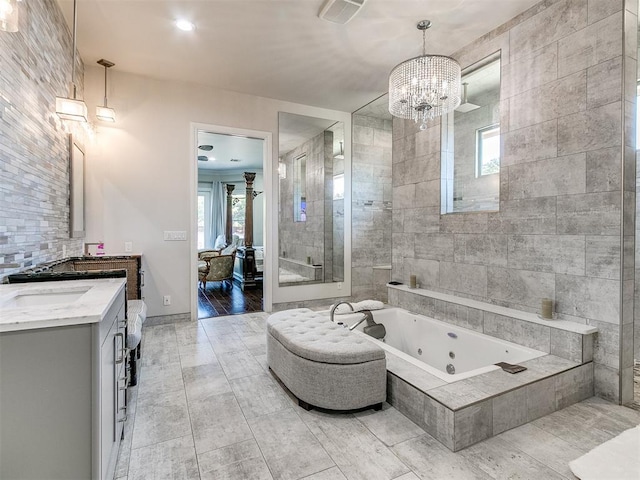 6363 NW 220th St, Edmond, OK 73025 - full bathroom with a shower stall, a jetted tub, visible vents, vanity, and a chandelier