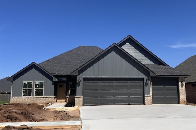 3404 Slate River Dr, Yukon, OK 73099 - view of front of property featuring a garage, driveway, brick siding, and a shingled roof
