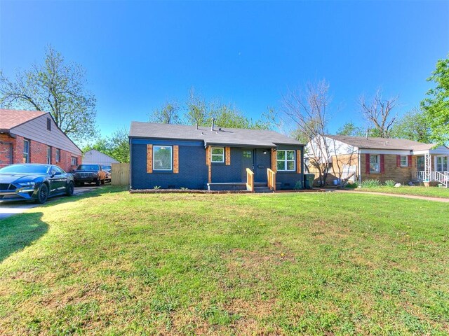 view of front of home with brick siding and a front yard