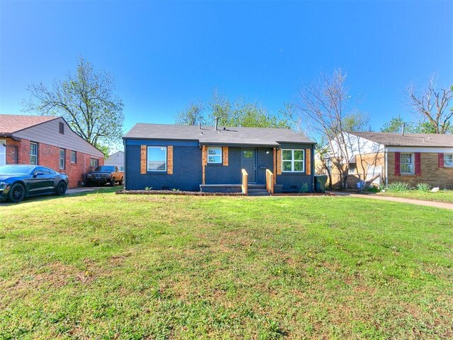 bungalow-style home with a front yard