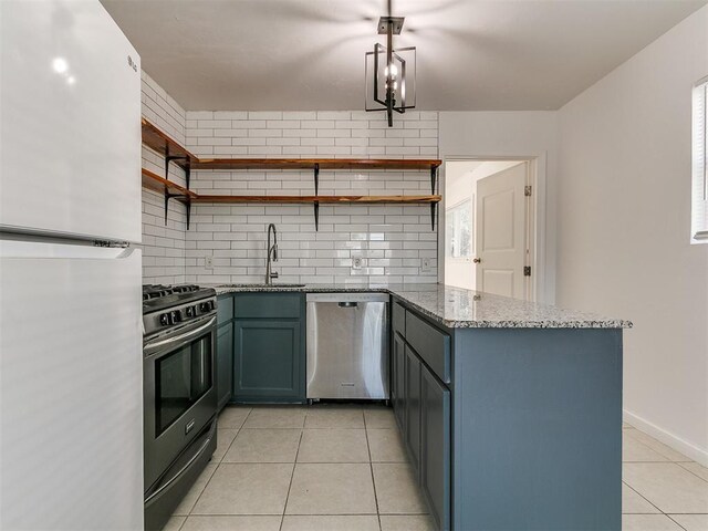 kitchen featuring open shelves, light tile patterned floors, a sink, a peninsula, and appliances with stainless steel finishes