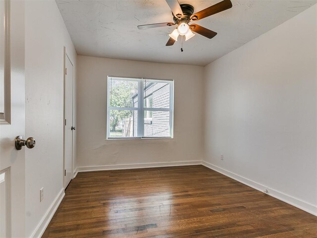 spare room featuring baseboards, a ceiling fan, and wood finished floors