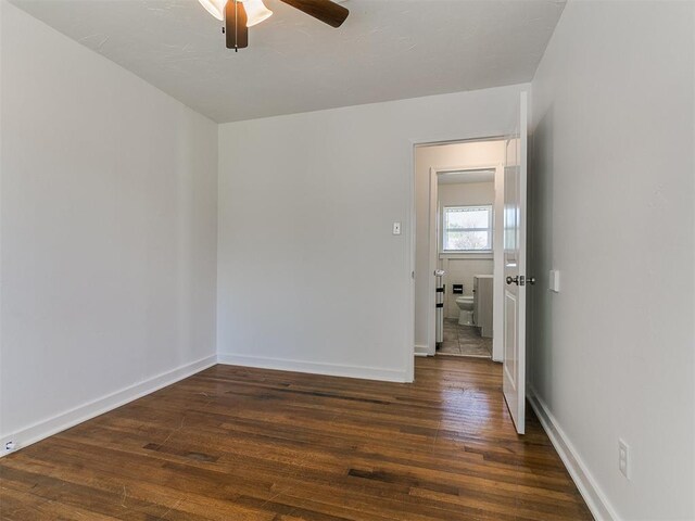 empty room with hardwood / wood-style floors, baseboards, and ceiling fan