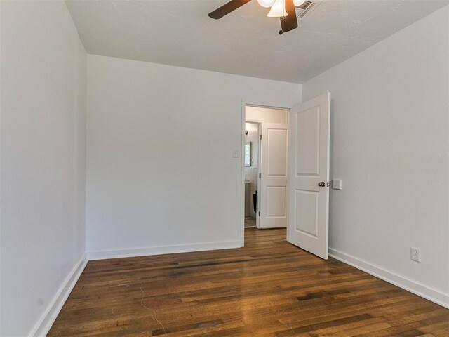 unfurnished room with visible vents, baseboards, wood finished floors, and ceiling fan