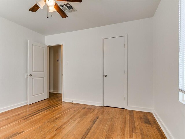 unfurnished bedroom with baseboards, a ceiling fan, light wood-style floors, and visible vents
