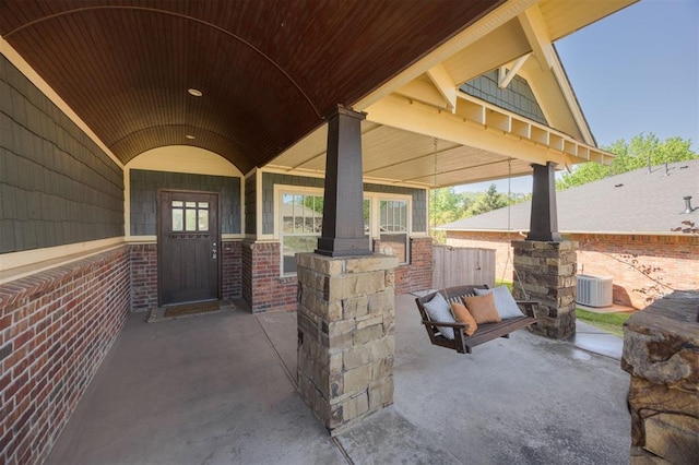 4940 Sonny Blues Pl, Edmond, OK 73034 - entrance to property with brick siding, central air condition unit, and a patio