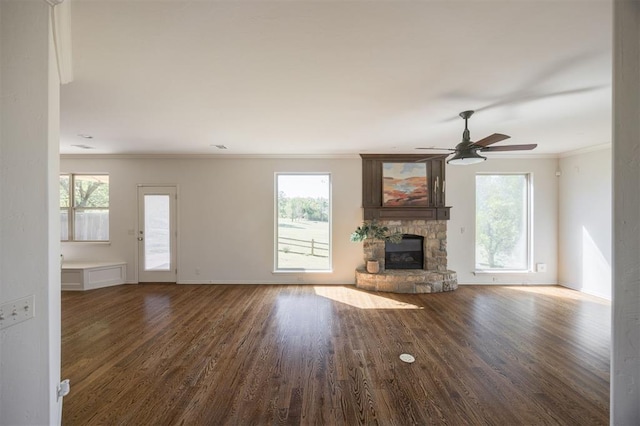 4940 Sonny Blues Pl, Edmond, OK 73034 - unfurnished living room featuring a wealth of natural light, crown molding, wood finished floors, and a fireplace