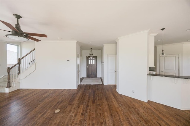 4940 Sonny Blues Pl, Edmond, OK 73034 - unfurnished living room featuring stairway, ceiling fan, dark wood-style flooring, and ornamental molding