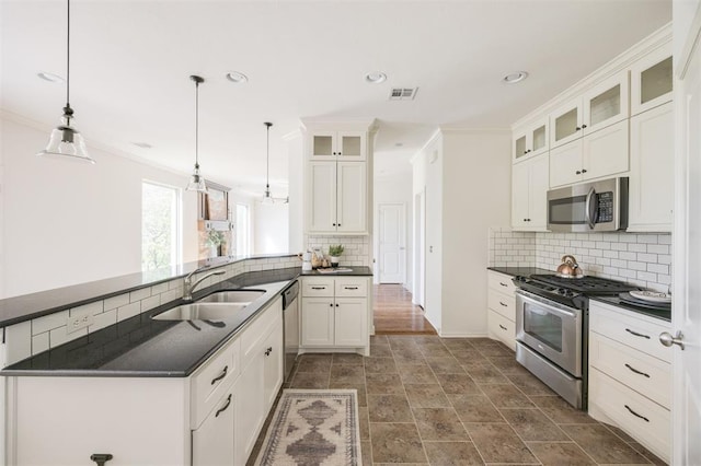 4940 Sonny Blues Pl, Edmond, OK 73034 - kitchen with backsplash, stainless steel appliances, visible vents, and a sink
