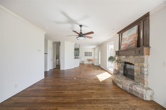 4940 Sonny Blues Pl, Edmond, OK 73034 - unfurnished living room featuring a fireplace, ceiling fan, crown molding, and dark wood-style flooring