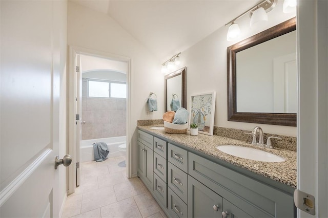 4940 Sonny Blues Pl, Edmond, OK 73034 - bathroom with lofted ceiling, tile patterned flooring, double vanity, toilet, and a sink