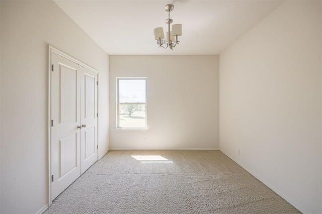4940 Sonny Blues Pl, Edmond, OK 73034 - empty room with baseboards, an inviting chandelier, and carpet