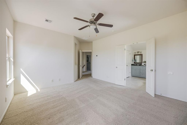 4940 Sonny Blues Pl, Edmond, OK 73034 - unfurnished bedroom with ceiling fan, light carpet, baseboards, ensuite bath, and visible vents