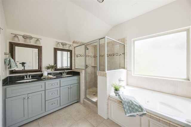 4940 Sonny Blues Pl, Edmond, OK 73034 - bathroom featuring tile patterned floors, vaulted ceiling, a sink, and a stall shower