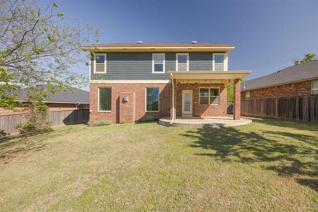 4940 Sonny Blues Pl, Edmond, OK 73034 - rear view of house with a lawn, a patio area, a fenced backyard, and brick siding
