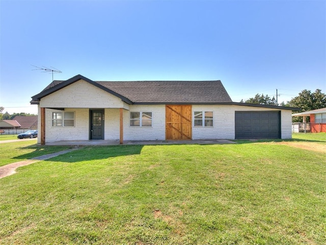 603 N Madison Ave, Blanchard, OK 73010 - view of front of home featuring a garage, roof with shingles, a front yard, and brick siding