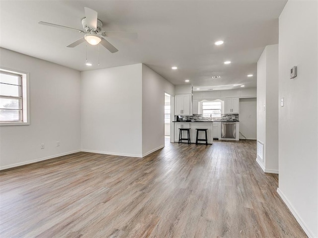 603 N Madison Ave, Blanchard, OK 73010 - unfurnished living room featuring baseboards, recessed lighting, and light wood-style floors