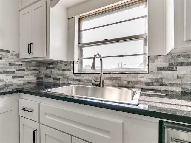 603 N Madison Ave, Blanchard, OK 73010 - kitchen featuring backsplash, dark countertops, white cabinetry, and a sink