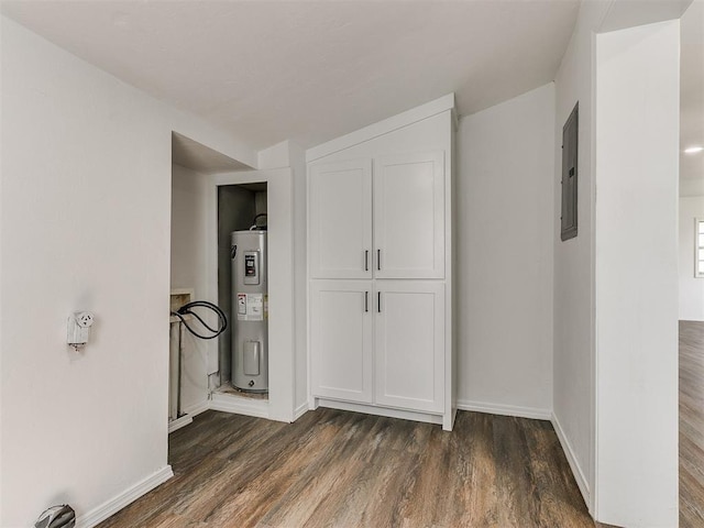 603 N Madison Ave, Blanchard, OK 73010 - hallway with baseboards, electric water heater, dark wood-type flooring, and electric panel