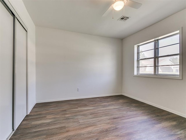 603 N Madison Ave, Blanchard, OK 73010 - unfurnished bedroom featuring wood finished floors, visible vents, a ceiling fan, a closet, and baseboards