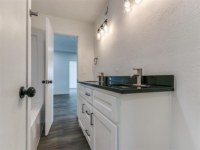 603 N Madison Ave, Blanchard, OK 73010 - bathroom with visible vents, wood finished floors, a sink, and double vanity