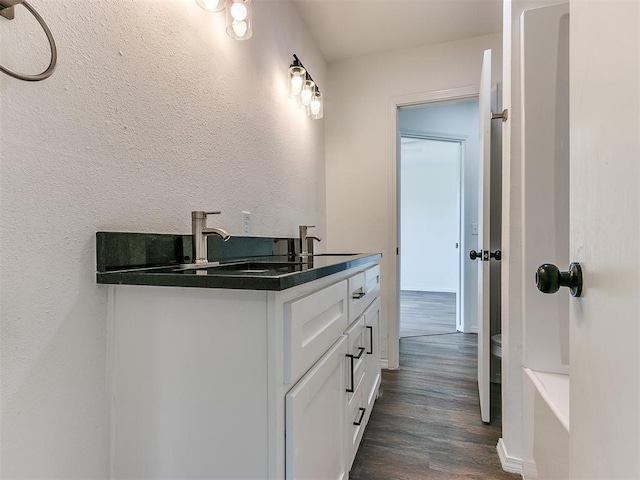603 N Madison Ave, Blanchard, OK 73010 - full bathroom featuring double vanity, wood finished floors, and a sink