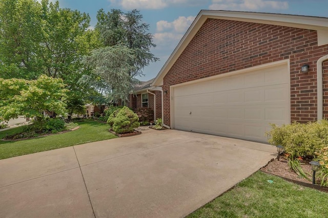 1117 Blue Ridge Dr, Edmond, OK 73003 - view of side of home with brick siding, driveway, an attached garage, and a lawn