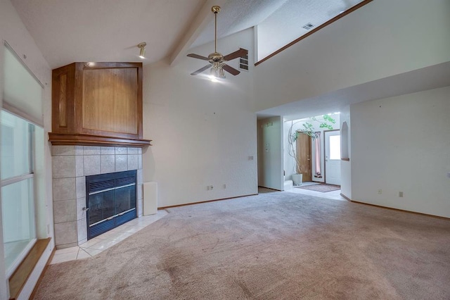 1117 Blue Ridge Dr, Edmond, OK 73003 - unfurnished living room with a tile fireplace, ceiling fan, light colored carpet, baseboards, and beamed ceiling