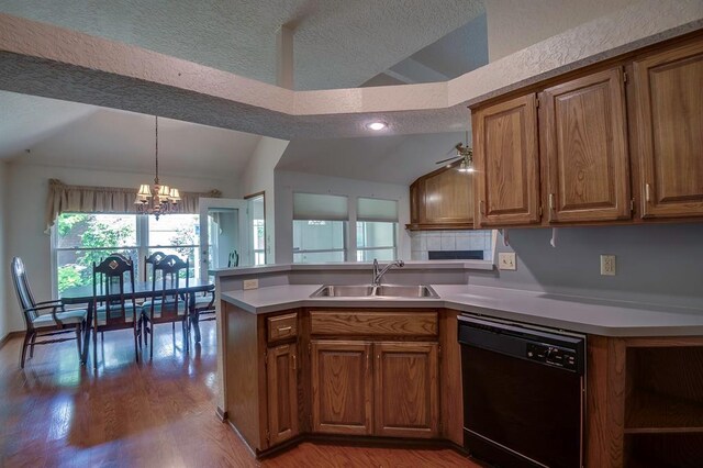 1117 Blue Ridge Dr, Edmond, OK 73003 - kitchen with dishwasher, vaulted ceiling, a sink, brown cabinets, and a chandelier