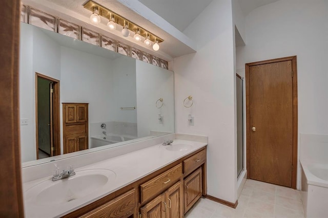 1117 Blue Ridge Dr, Edmond, OK 73003 - bathroom featuring a garden tub, a stall shower, double vanity, and tile patterned flooring