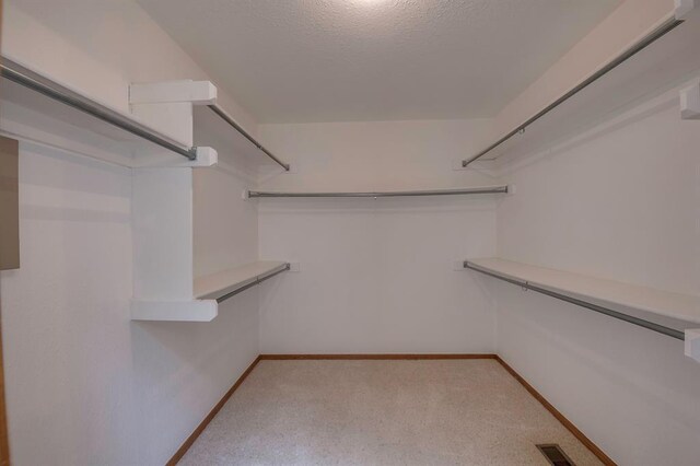 1117 Blue Ridge Dr, Edmond, OK 73003 - walk in closet with light colored carpet