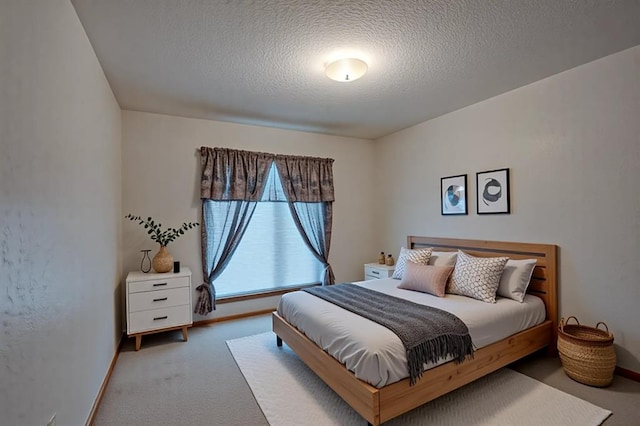 1117 Blue Ridge Dr, Edmond, OK 73003 - bedroom featuring carpet floors, a textured ceiling, and baseboards