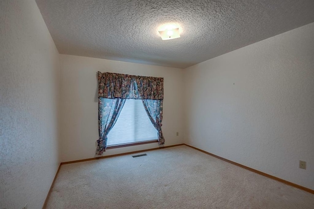 1117 Blue Ridge Dr, Edmond, OK 73003 - spare room with carpet, a textured ceiling, a textured wall, and baseboards