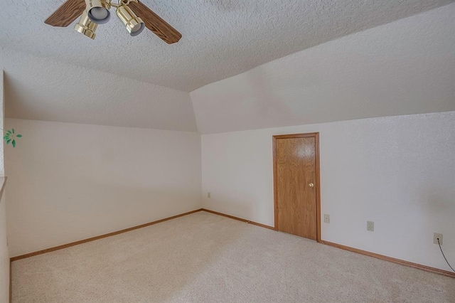 1117 Blue Ridge Dr, Edmond, OK 73003 - additional living space with light colored carpet, ceiling fan, lofted ceiling, a textured ceiling, and baseboards