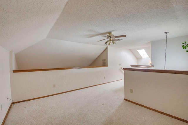 1117 Blue Ridge Dr, Edmond, OK 73003 - additional living space featuring carpet, a skylight, a ceiling fan, baseboards, and lofted ceiling