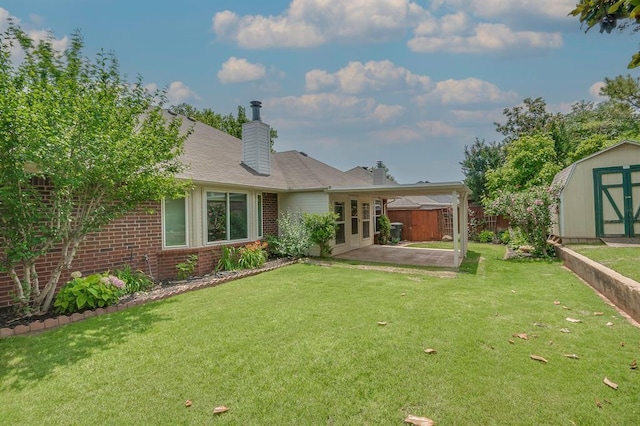 1117 Blue Ridge Dr, Edmond, OK 73003 - back of property with a patio area, brick siding, and a chimney