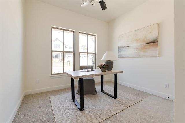 carpeted home office with baseboards, a wealth of natural light, and ceiling fan