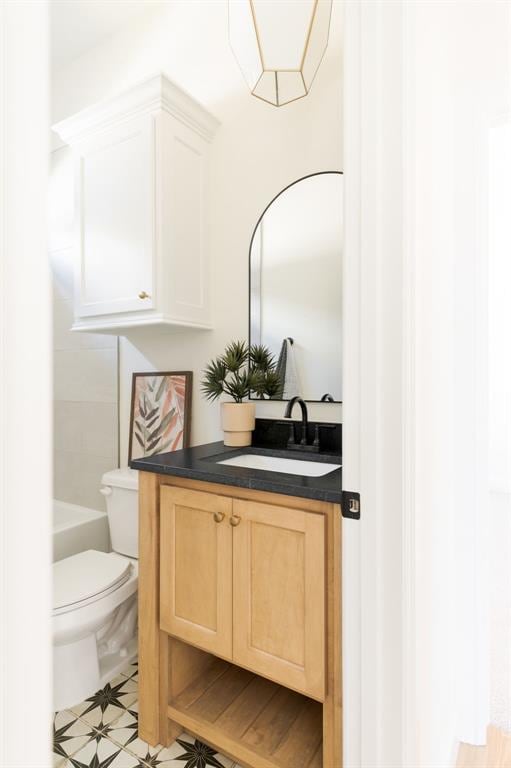 bathroom featuring toilet, vanity, and tile patterned floors