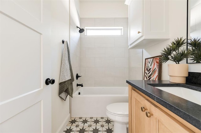 bathroom featuring toilet, vanity, and  shower combination