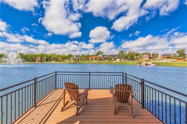 wooden terrace featuring a water view