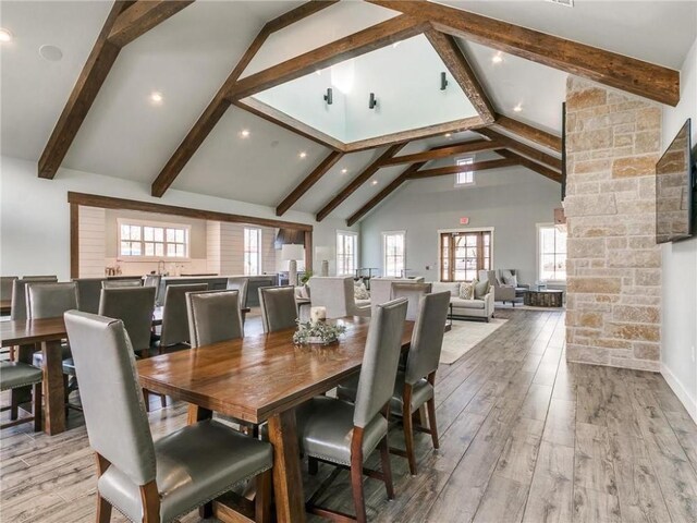 dining area with high vaulted ceiling, recessed lighting, beam ceiling, and light wood-style flooring
