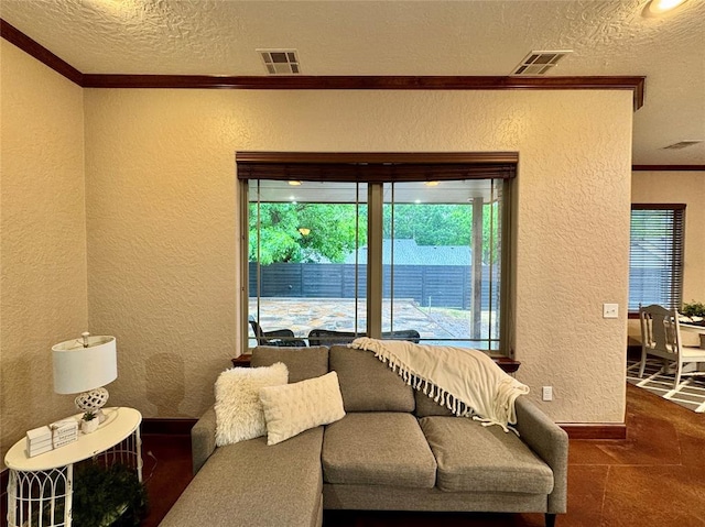 living room with visible vents, a textured wall, baseboards, ornamental molding, and a textured ceiling