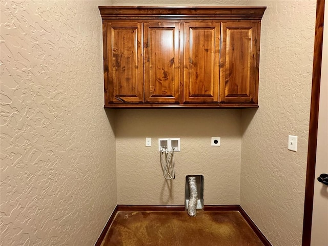 clothes washing area with cabinet space, washer hookup, electric dryer hookup, a textured wall, and baseboards