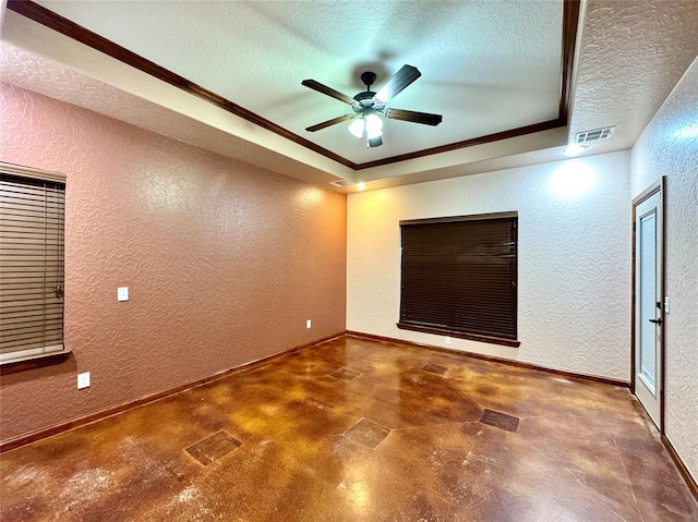 unfurnished room with finished concrete flooring, a textured ceiling, a textured wall, and visible vents